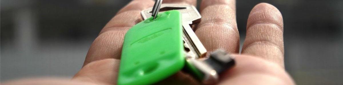 a landlord's rental property keys in a hand